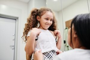 a young child gets ready for school